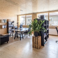 Photograph of an office interior finished entirely in wood with modern furnishing in the Lattich building in St. Gallen