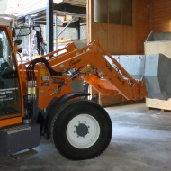 A tractor feeds a module conveyor system with salt