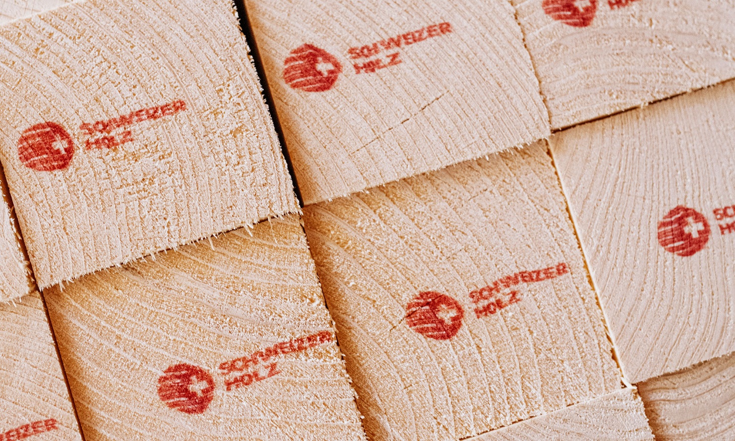 Close-up of square timber, printed with the Swiss timber logo